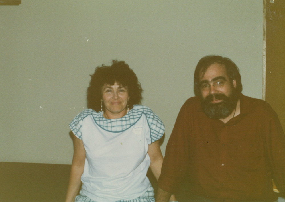 A woman and a man looking at the camera and smiling