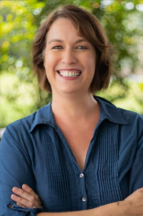 photo of Sonia Adolphs standing in front of a tree smiling at the camera