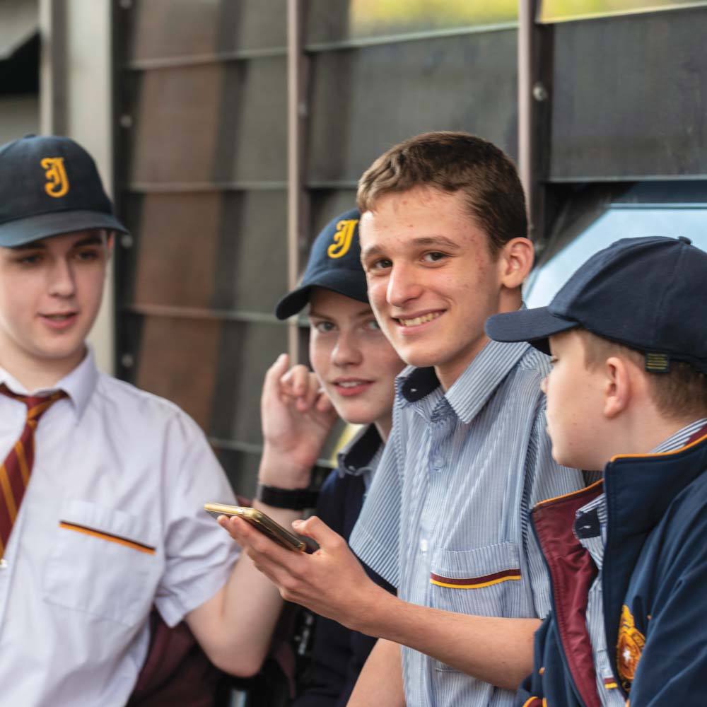 Group of boys in school uniform talking