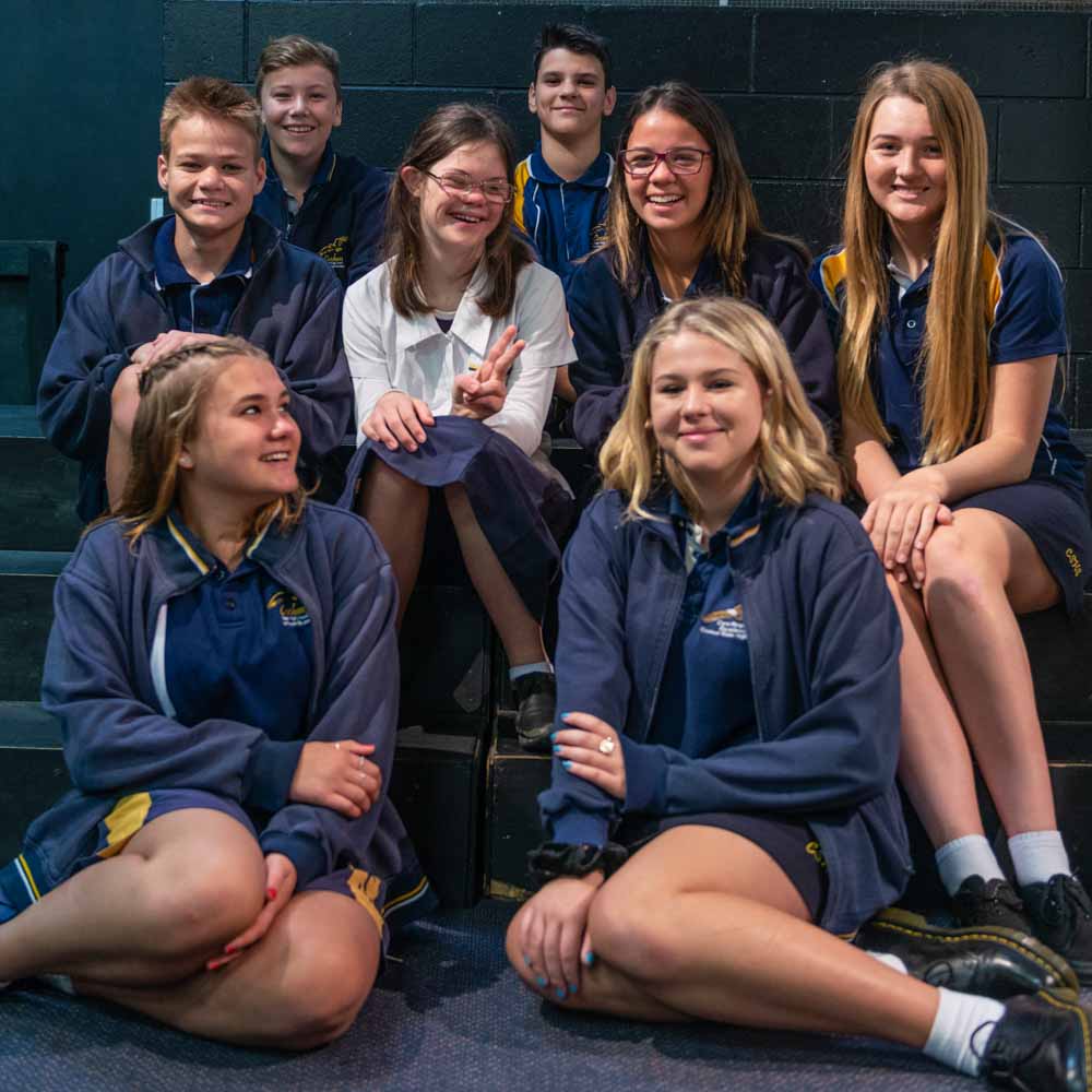 Group of kids in school uniform sitting in a group