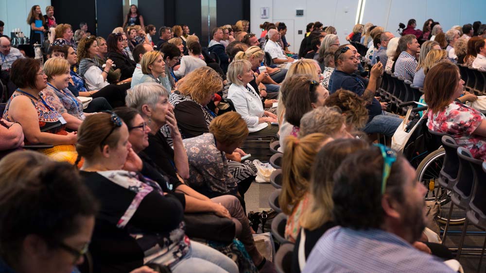 A group of people at a cru conference.  A wide variety of people all looking engaged and interested in the content