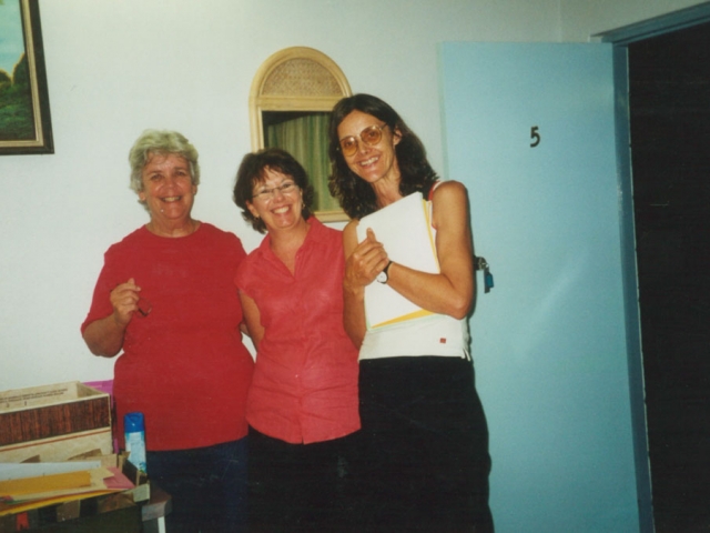 3 women standing close together and smiling warmly