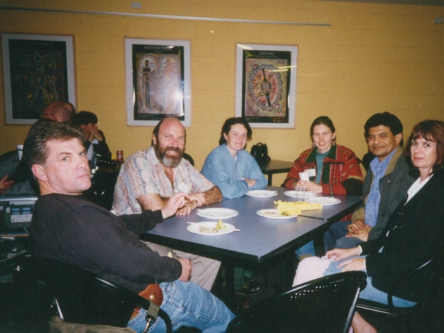 A group of 6 people sitting around a table at a restaurant