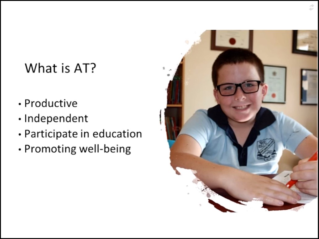 'What is AT' slide with a pic of a smiling boy in school uniform wearing glasses