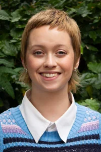 Jess with short blond hair and a happy smile