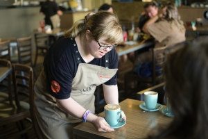 Woman serving a coffee